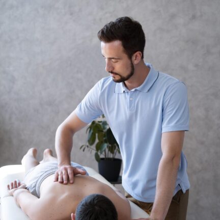 medium-shot-physiotherapist-massaging-boy