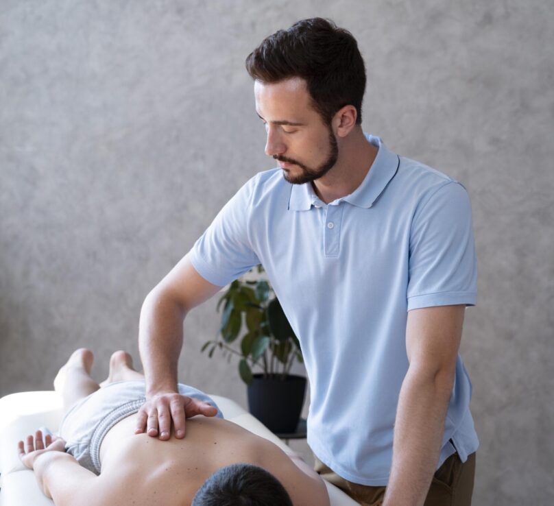 medium-shot-physiotherapist-massaging-boy